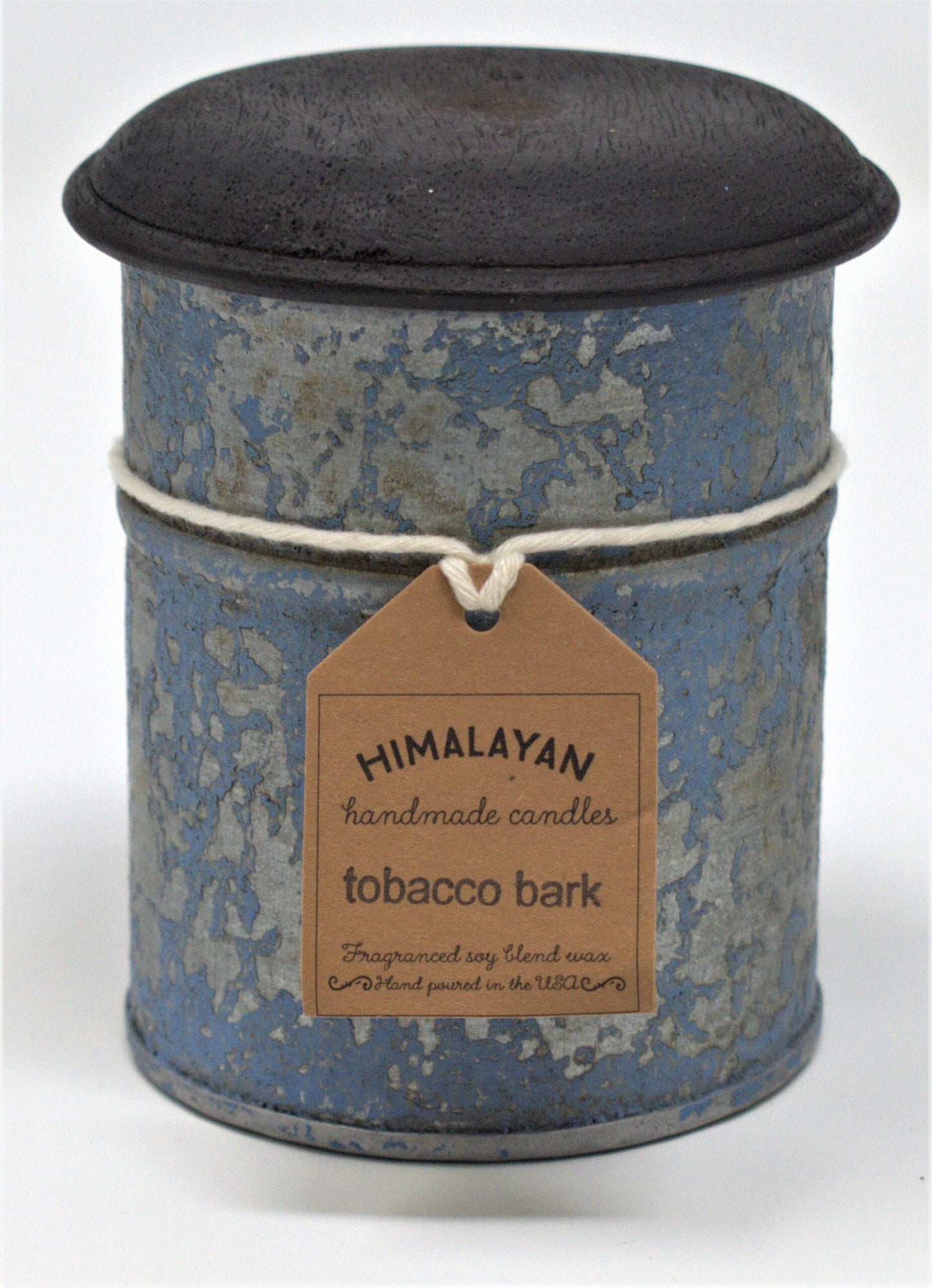 Cylindrical candle in a blue tin with a black lid, featuring a 'Himalayan Handmade Candles' label.