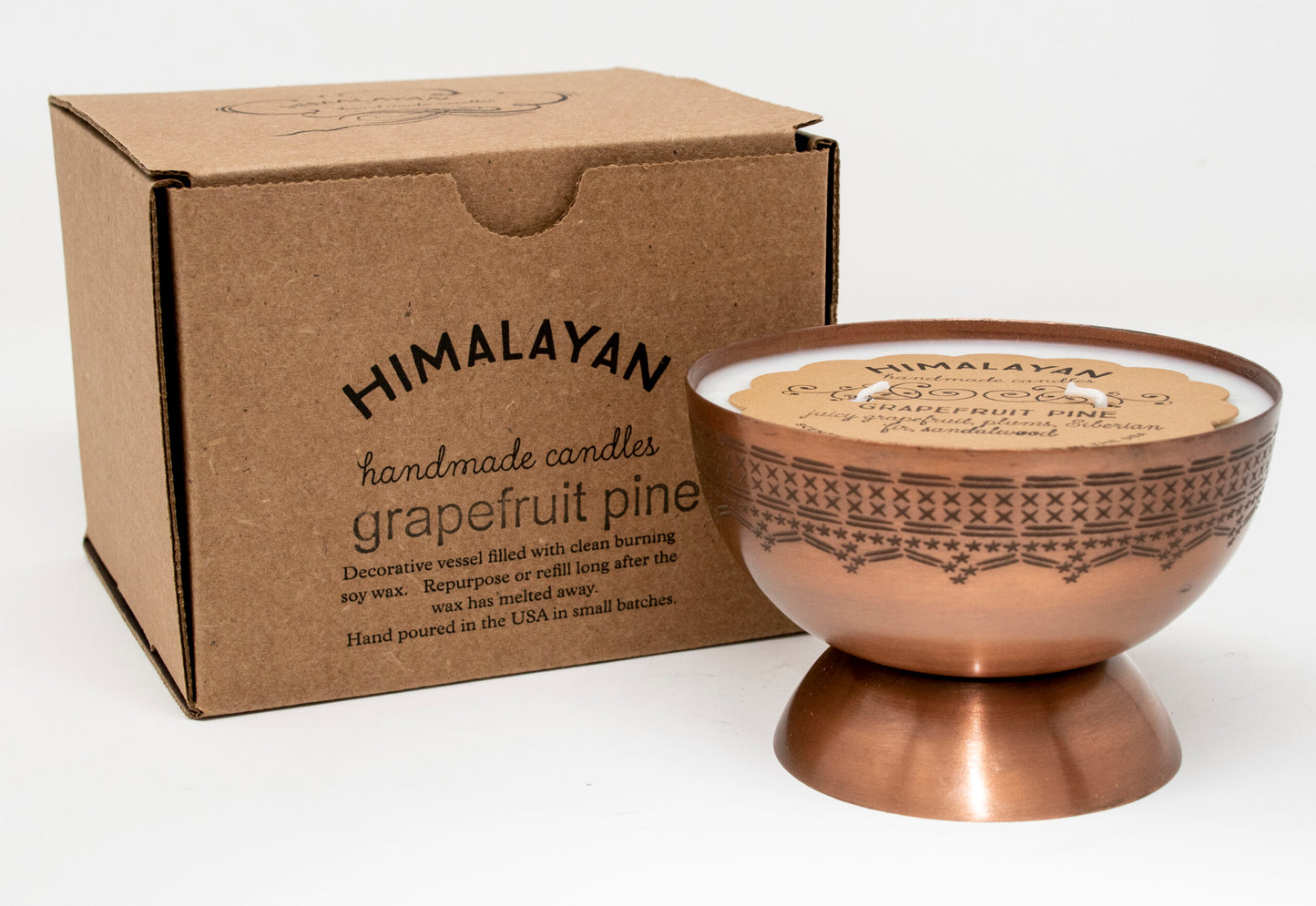 Himalayan handmade candles grapefruit branded cardboard box with bronze candle in a bowl shape with pedestal on a white background