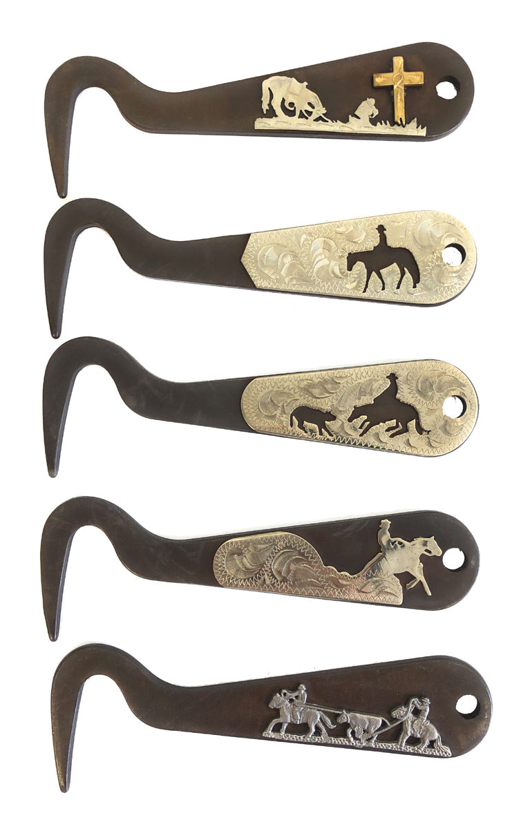 Five metal hoof pick with engraved designs on a handle, on white background.