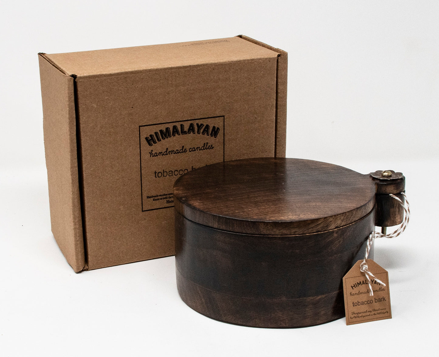 Brown wooden container with a lid and 'Himalayan Handmade Candles' box on a white background