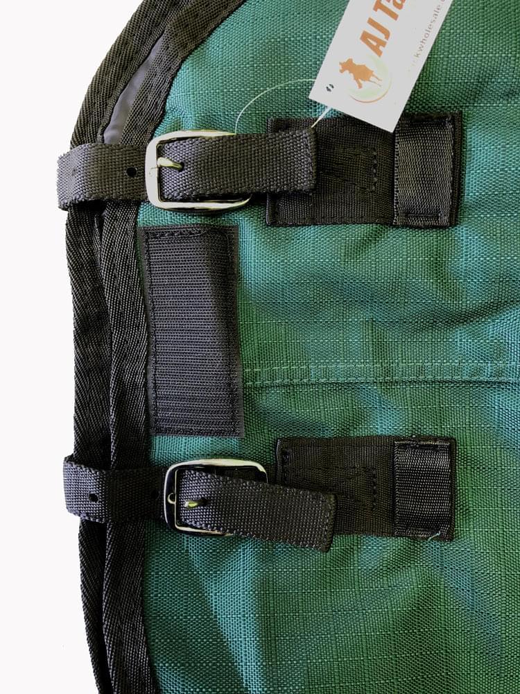 Portion of green horse blanket showing black straps and a visible brand tag on a white background