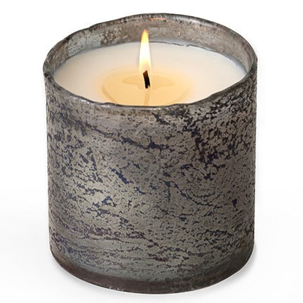 Glass candle, smokey grey texture with uneven rim, one wick burning in center.